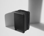 Angled product view of The Bigger Carry-On Flex suitcase in Jet Black