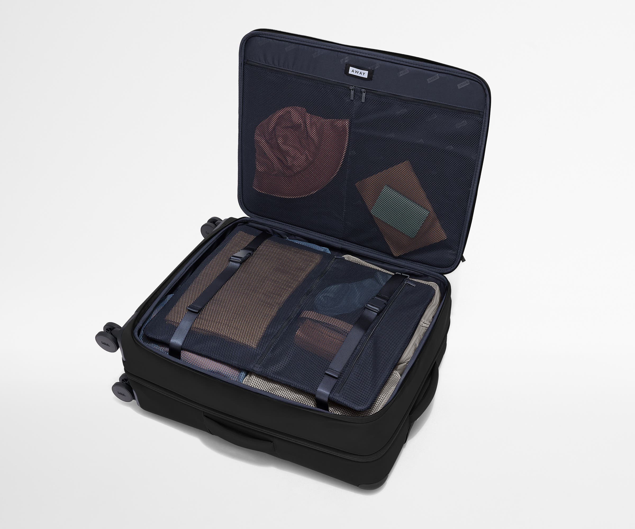 Open Softside suitcase, with travel essentials in the front flap pocket and compression pad pockets