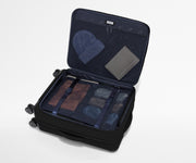 Open Softside suitcase, with travel essentials in the front flap pocket and compression pad pockets