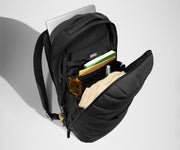 Hat, notebooks, and book in the main compartment. Keys attached to the key leash. Laptop in the exterior laptop pocket