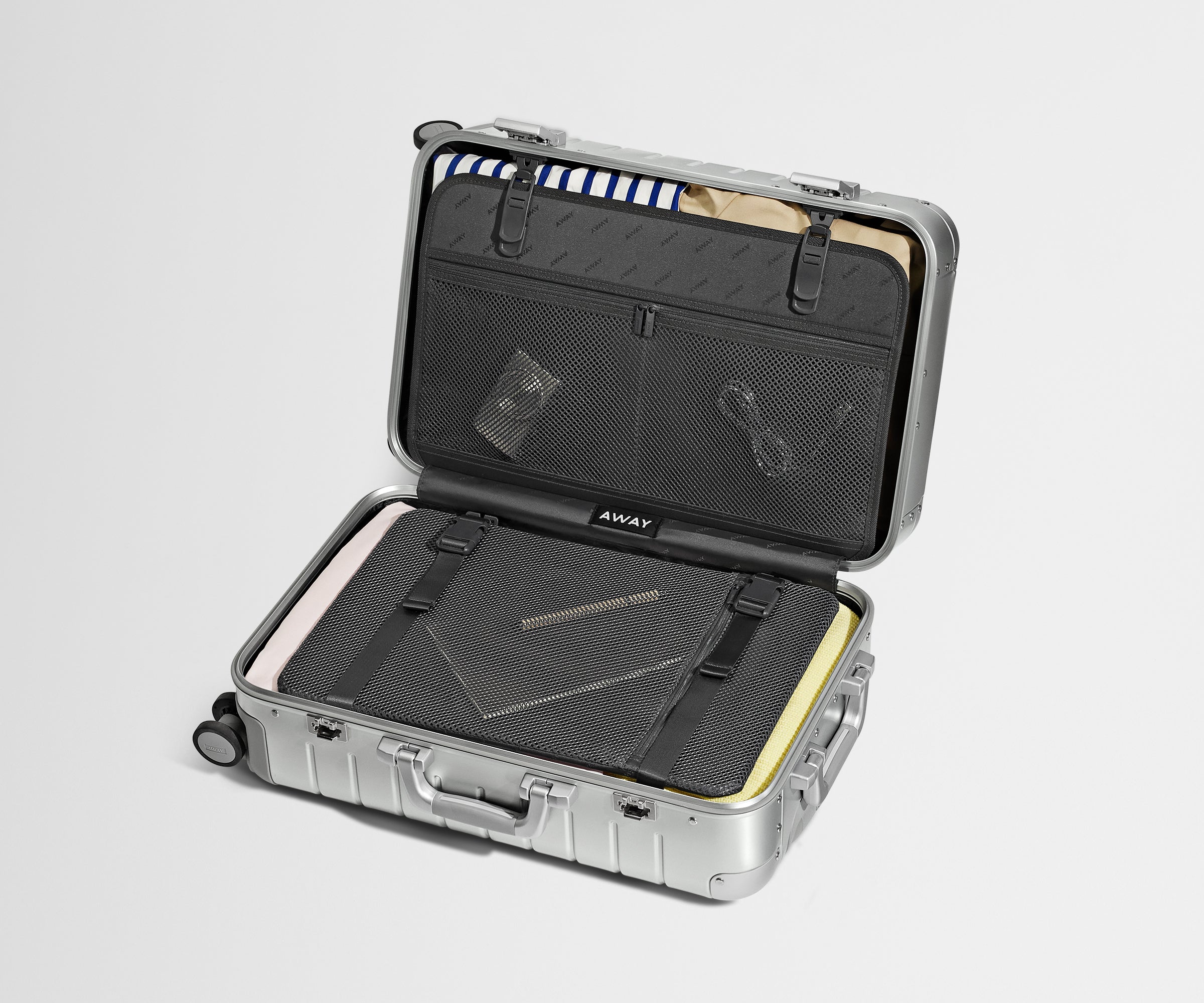 Packed Bigger Carry-On: Aluminum edition showing the compression pad system and interior organization