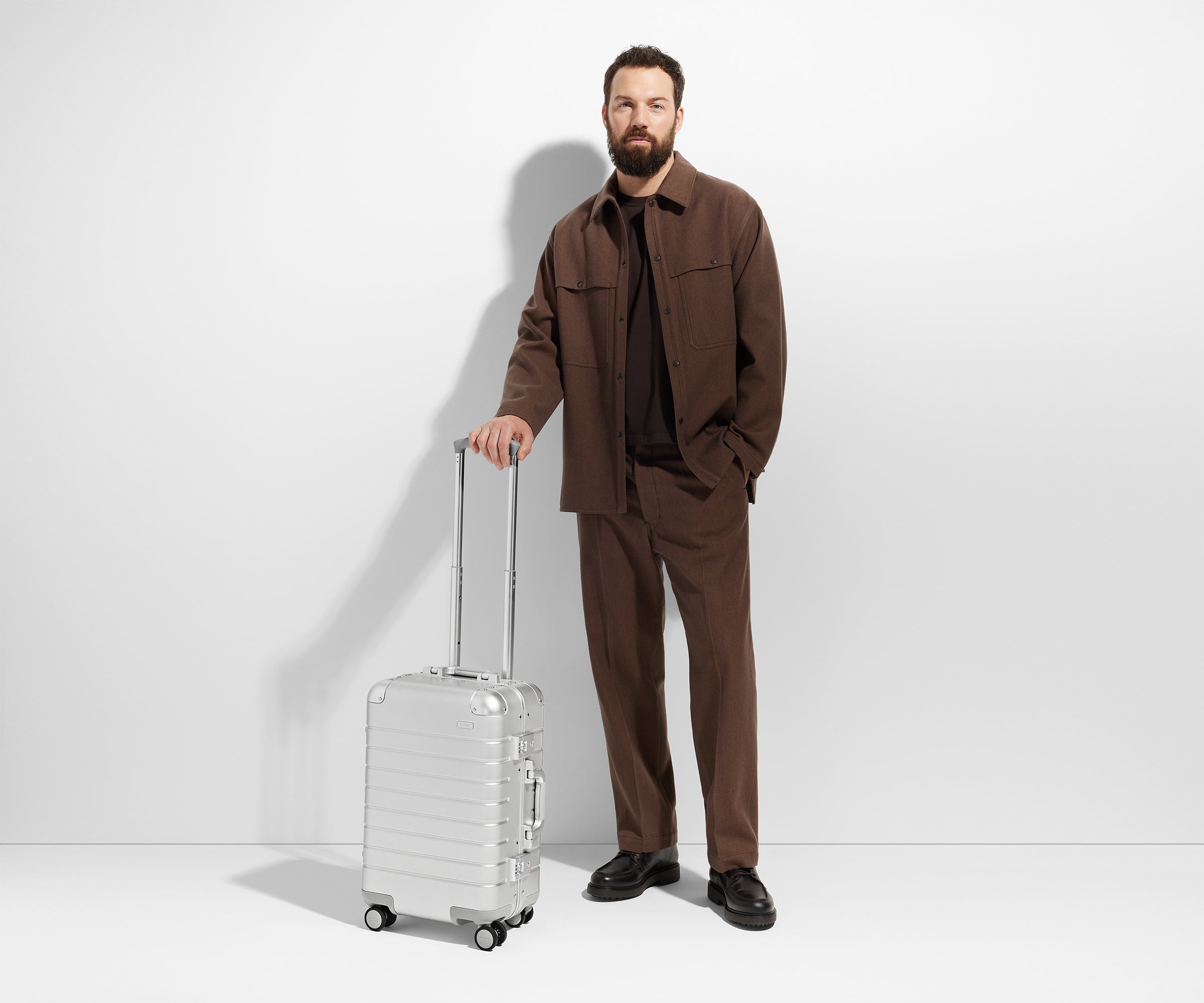 Person posing with an Aluminum Carry-On suitcase in Silver