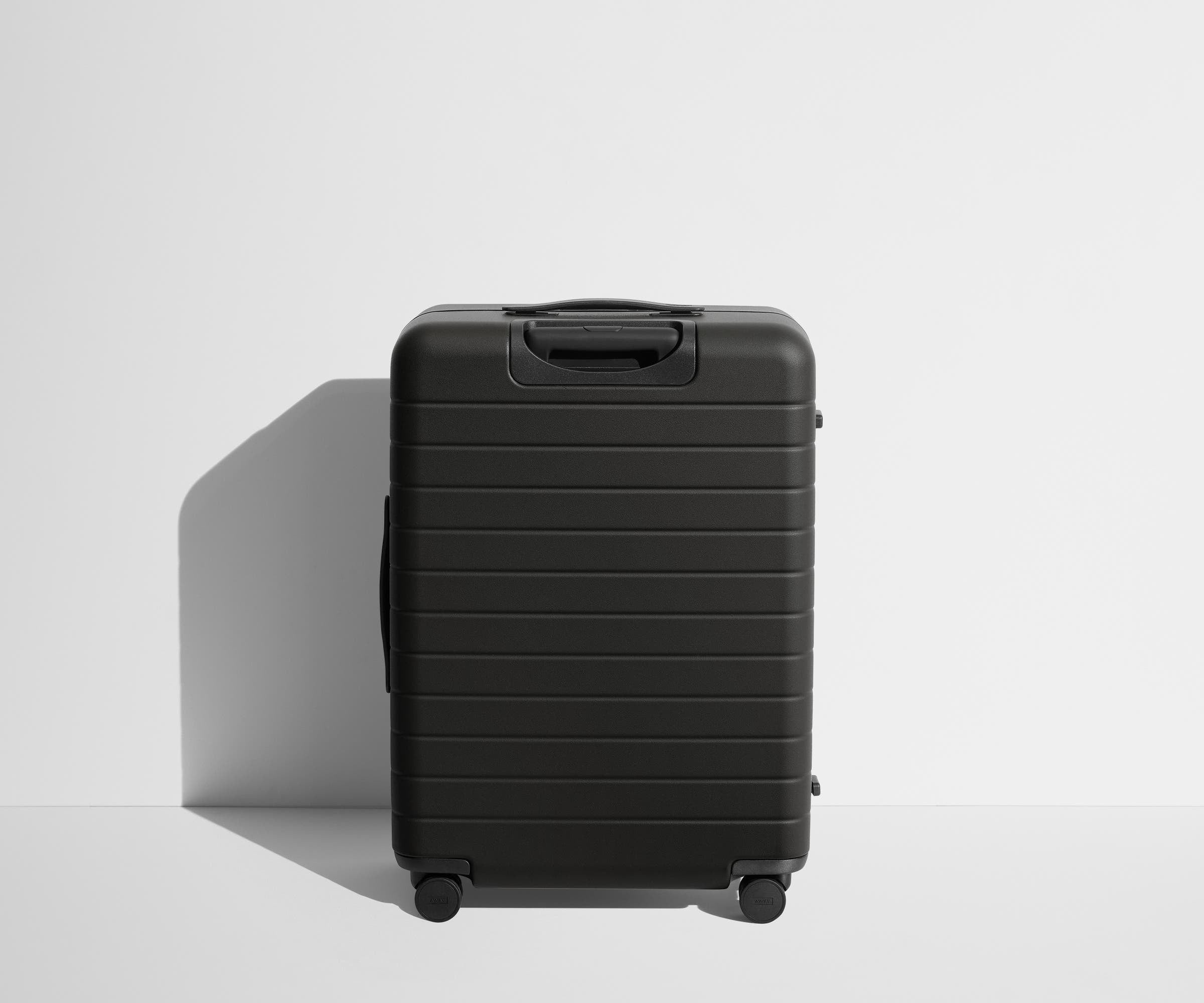 Back product view of The Medium Flex suitcase in Jet Black