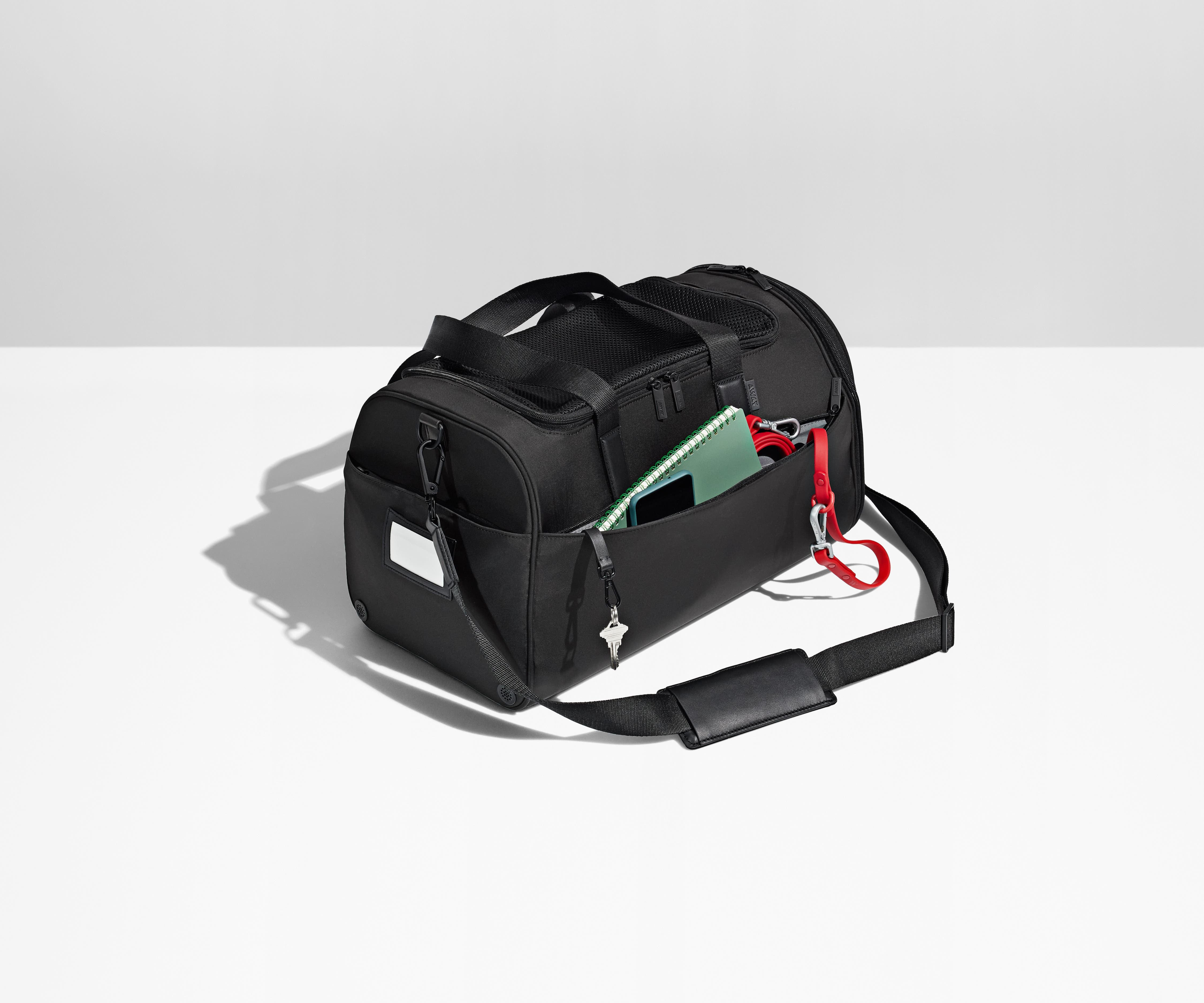 Notebook, leash, and keys packed in the exterior pockets and removable shoulder strap attached