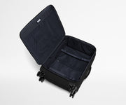 Open, unpacked Softside Medium suitcase, showing the depth of the bag and signature compression pad feature