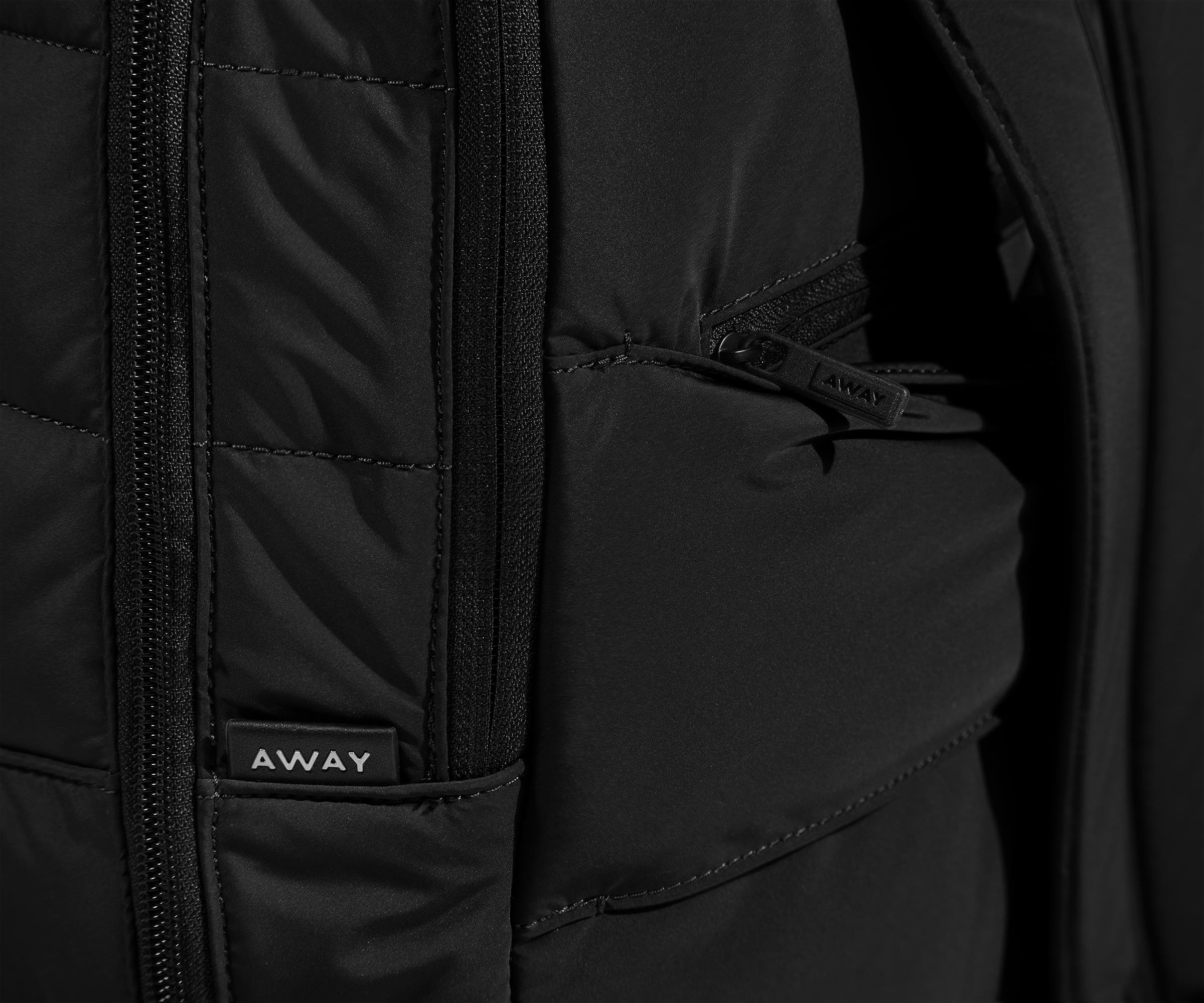 Close up view of the quilted material and hidden zip pocket behind the trolley sleeve