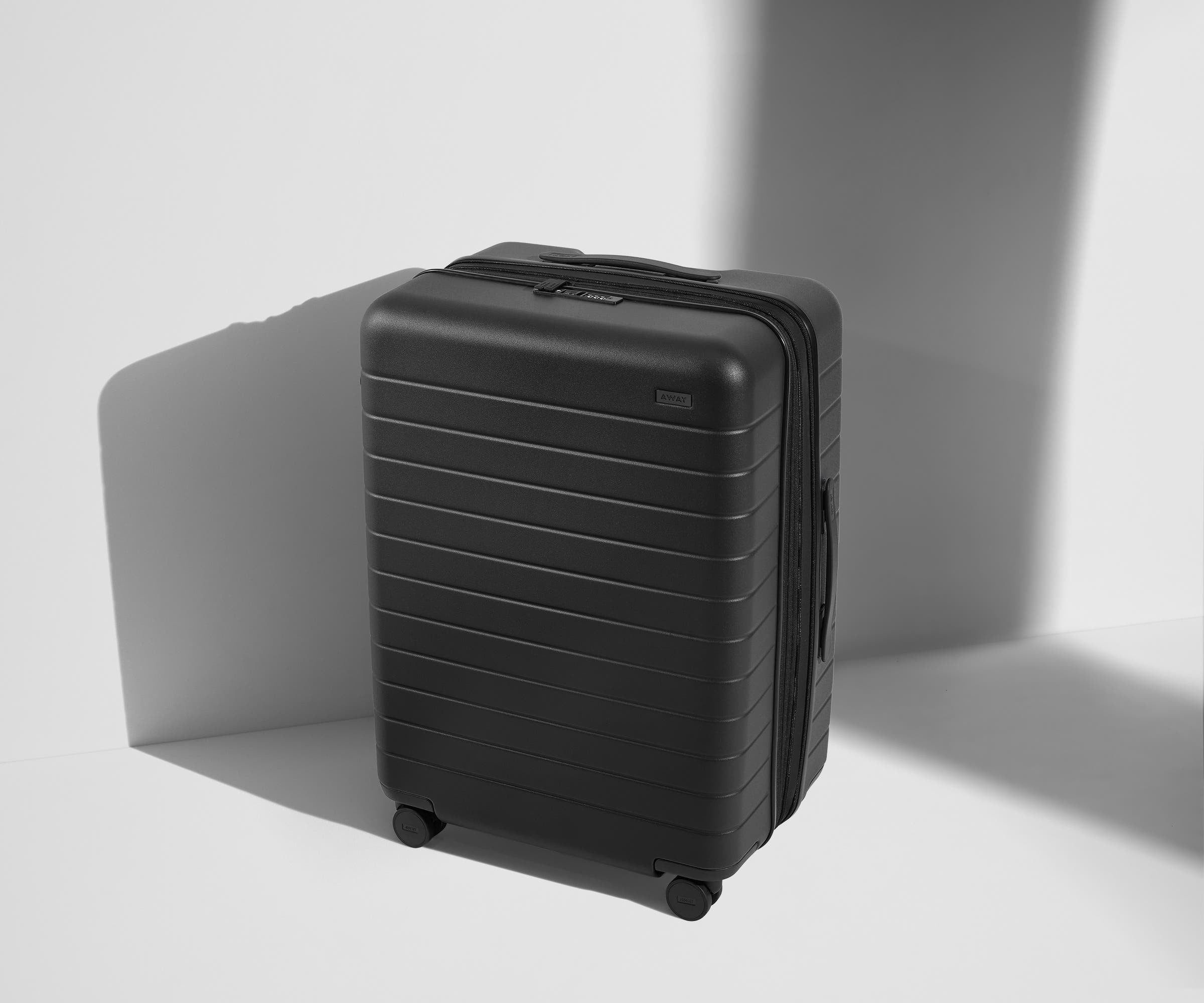 Angled product view of The Medium Flex suitcase in Jet Black